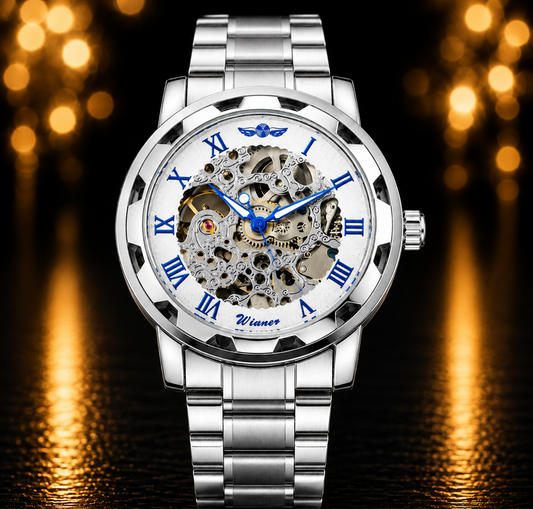 A luxury skeleton watch with a silver stainless steel case and link bracelet, featuring a white dial with Roman numerals and a visible mechanical movement inside. The watch is centered against a dark background with warm golden bokeh lights reflecting on a glossy surface.